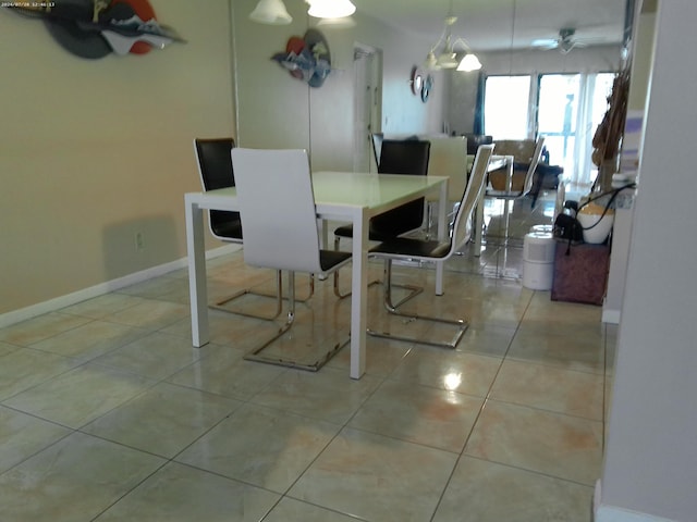 dining area with light tile patterned floors and ceiling fan