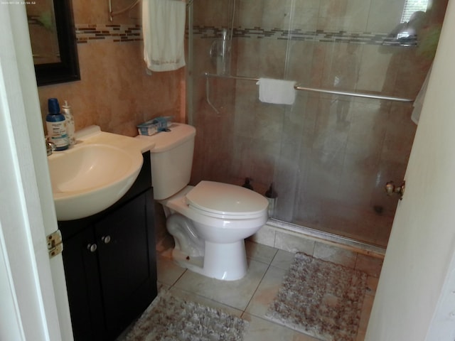 bathroom with walk in shower, tile patterned floors, toilet, and vanity