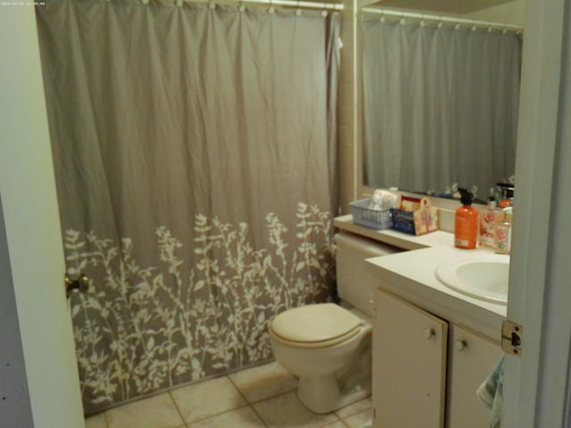 bathroom featuring tile patterned floors, toilet, and vanity