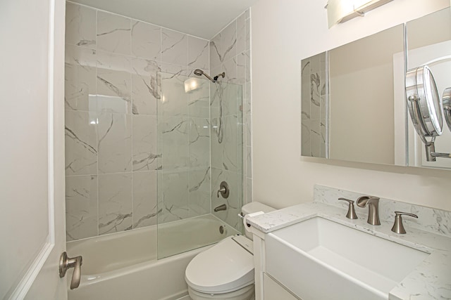 full bathroom featuring vanity, shower / bath combination with glass door, and toilet