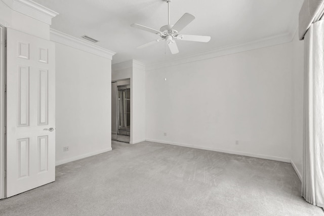 spare room featuring ceiling fan, ornamental molding, and light colored carpet