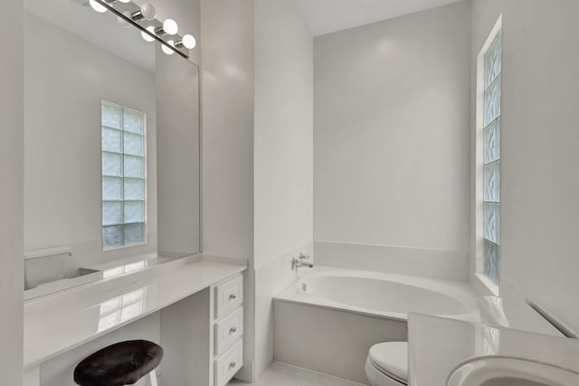 bathroom with vanity, toilet, and a bathtub