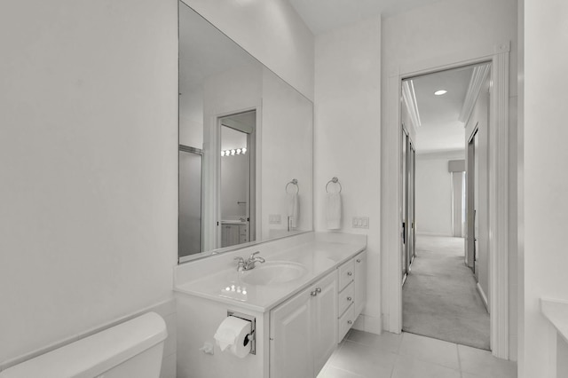 bathroom with toilet, tile patterned flooring, and vanity