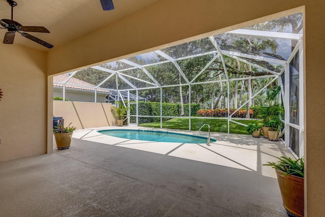 view of swimming pool with a patio, a lanai, and ceiling fan