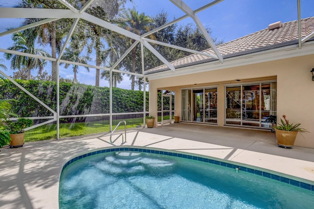 view of pool featuring glass enclosure and a patio