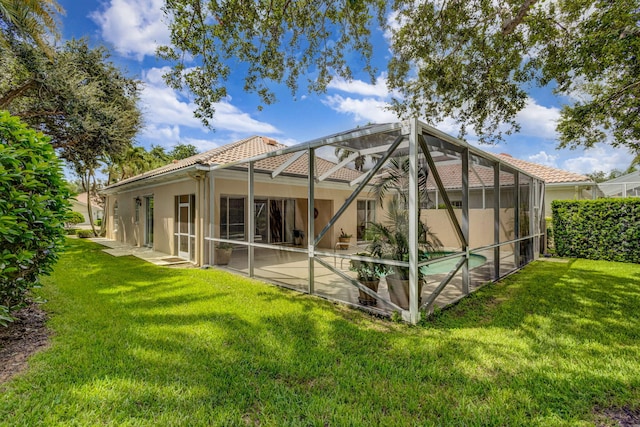 back of house with a lanai, a tile roof, a lawn, an outdoor pool, and a patio area