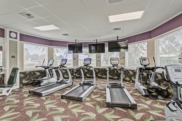 workout area with a paneled ceiling