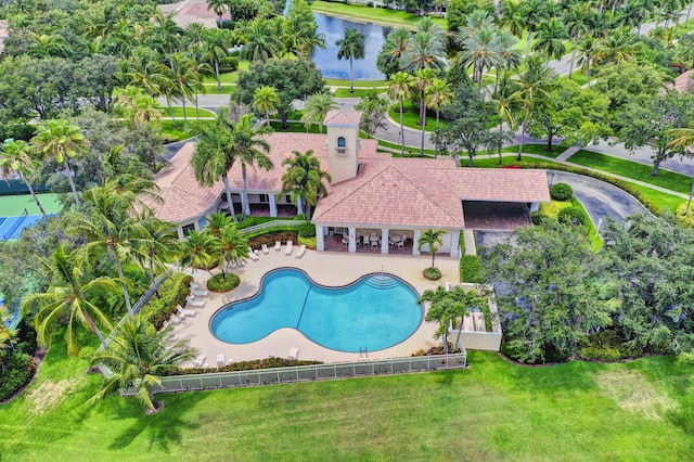 view of swimming pool featuring a patio area and a yard