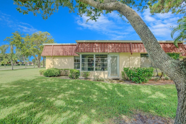 rear view of property featuring a yard