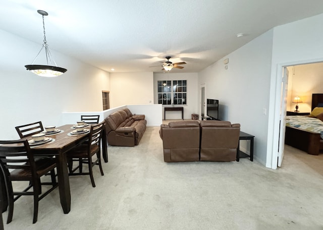 living room featuring light carpet and ceiling fan