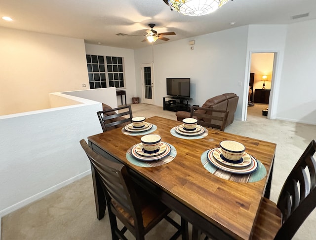 carpeted dining area featuring ceiling fan