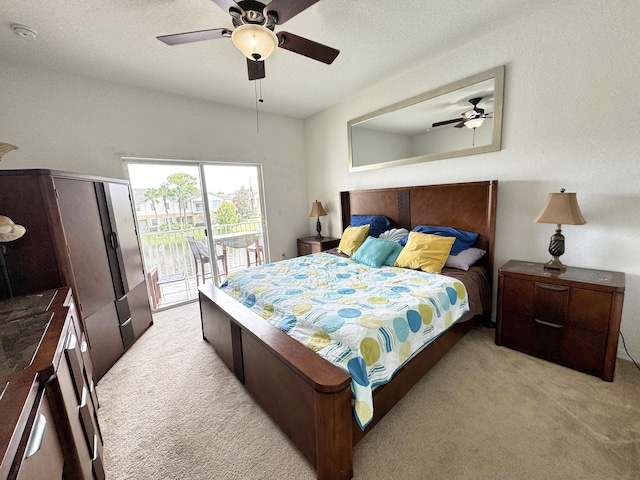 carpeted bedroom featuring ceiling fan, access to outside, and a textured ceiling