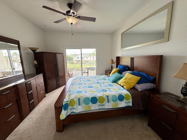 carpeted bedroom with access to exterior and ceiling fan