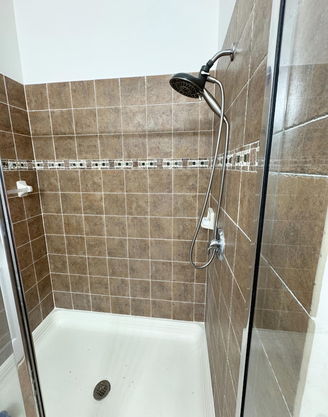 bathroom with tiled shower