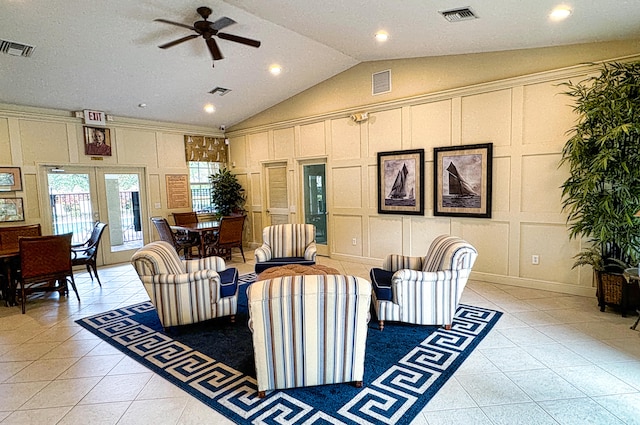 tiled living room featuring ceiling fan and vaulted ceiling