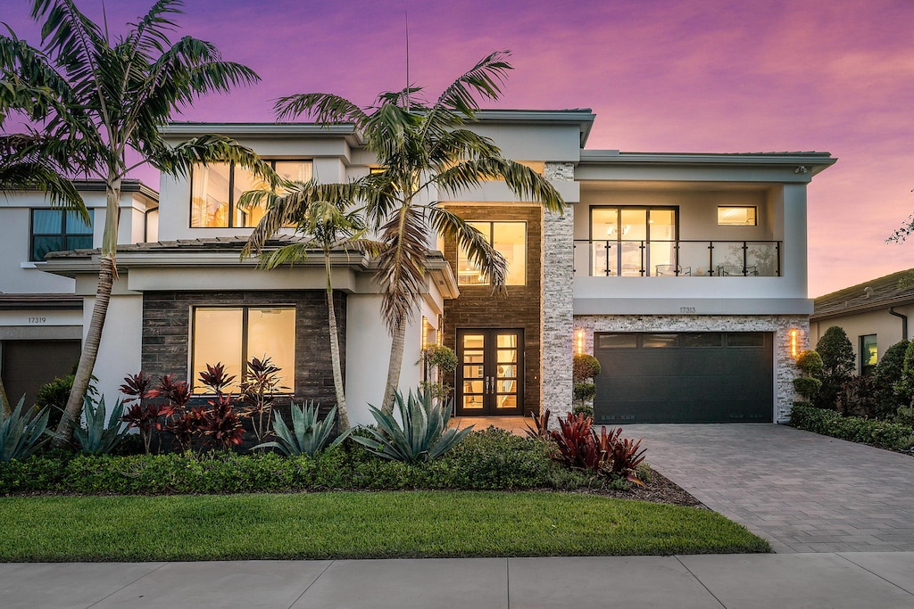 view of front of house featuring a balcony and a garage