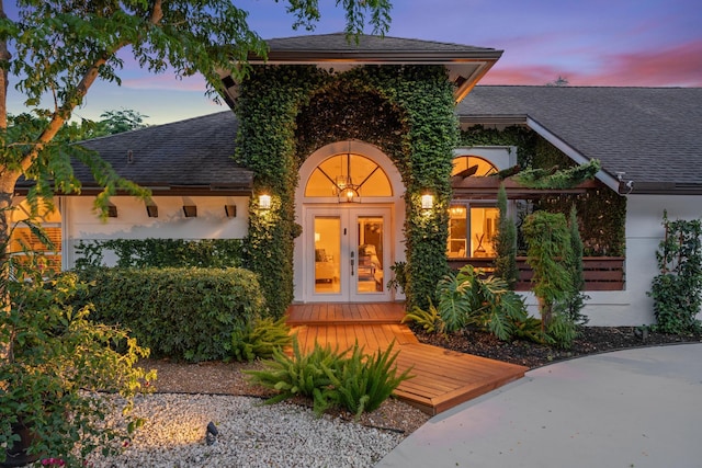 view of front of house featuring a deck and french doors