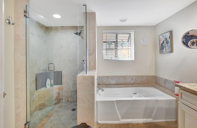 bathroom with vanity and independent shower and bath