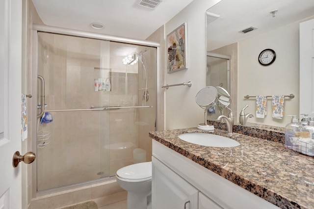 bathroom with walk in shower, vanity, toilet, and tile patterned flooring