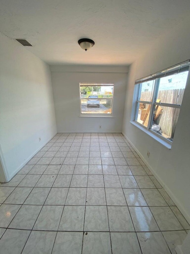 unfurnished room featuring light tile patterned floors