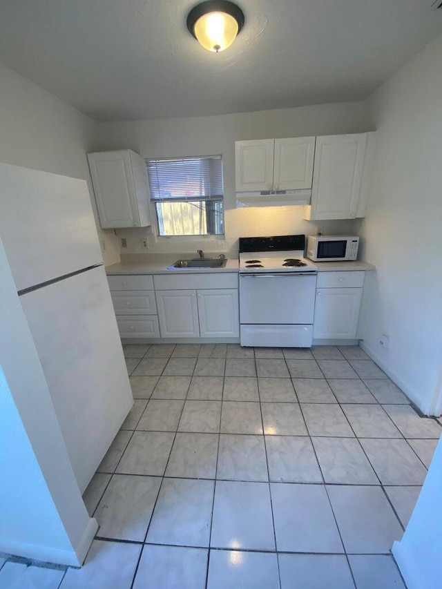 kitchen with light tile patterned flooring, white cabinetry, white appliances, and sink