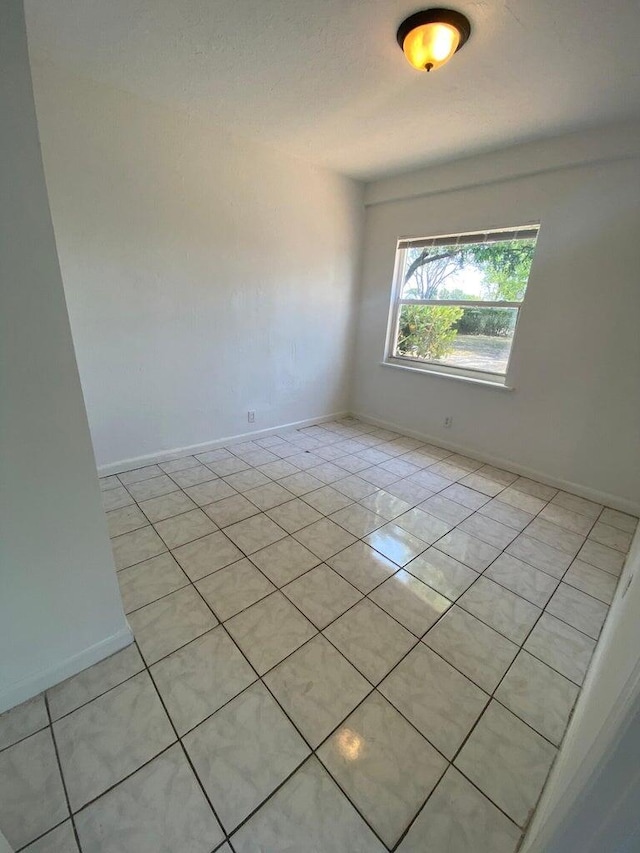 spare room with light tile patterned floors