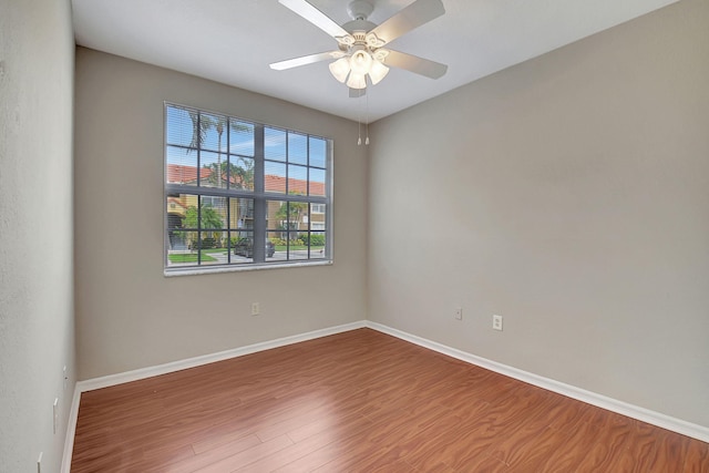 spare room featuring hardwood / wood-style floors and ceiling fan