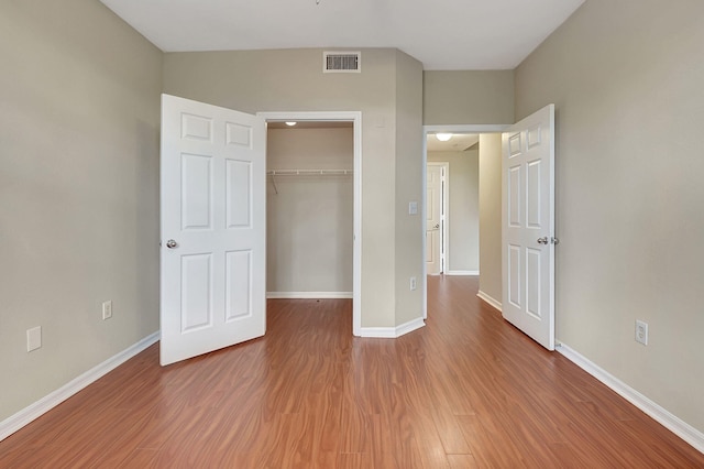 unfurnished bedroom featuring a closet and wood-type flooring