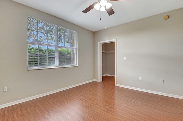 spare room featuring wood-type flooring and ceiling fan