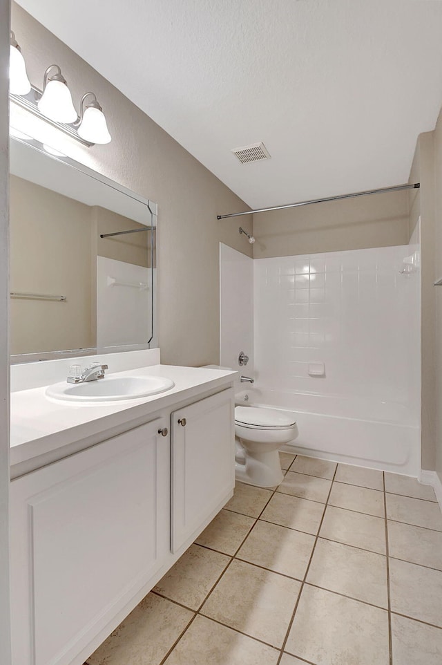 full bathroom with a textured ceiling, toilet, shower / tub combination, vanity, and tile patterned flooring