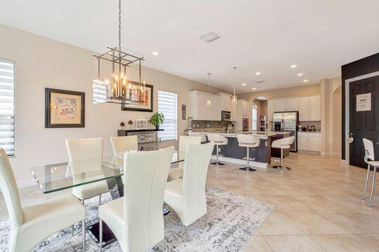 dining room featuring light tile patterned floors and a chandelier