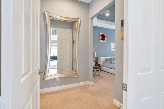 hallway featuring light colored carpet