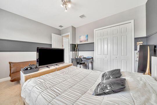 carpeted bedroom featuring a closet