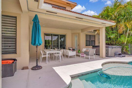 view of pool featuring a patio and a hot tub