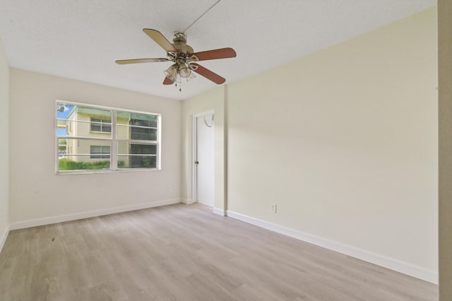 empty room with light wood-type flooring and ceiling fan