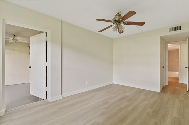 spare room with light hardwood / wood-style flooring and ceiling fan