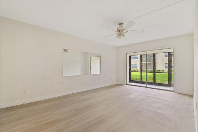 spare room featuring light hardwood / wood-style floors and ceiling fan