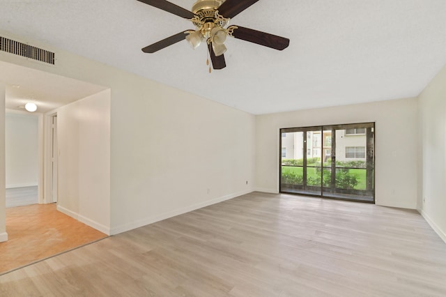 empty room with light wood-type flooring and ceiling fan