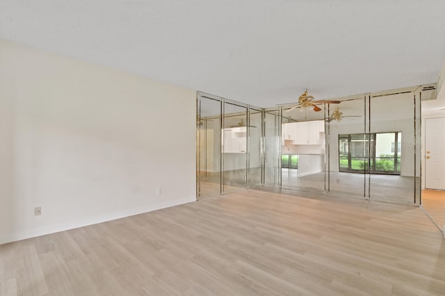 interior space with ceiling fan and light wood-type flooring