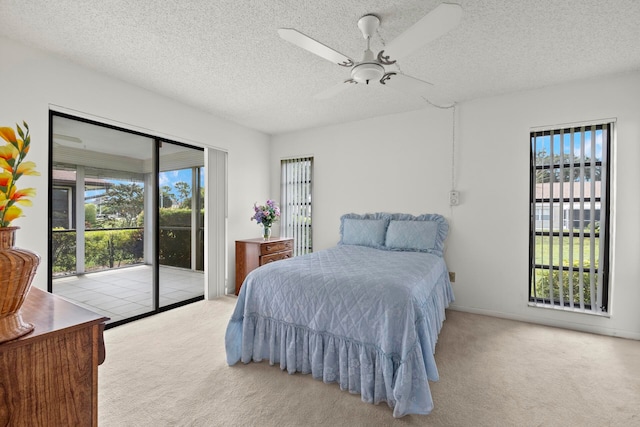 bedroom featuring access to outside, ceiling fan, light colored carpet, and multiple windows