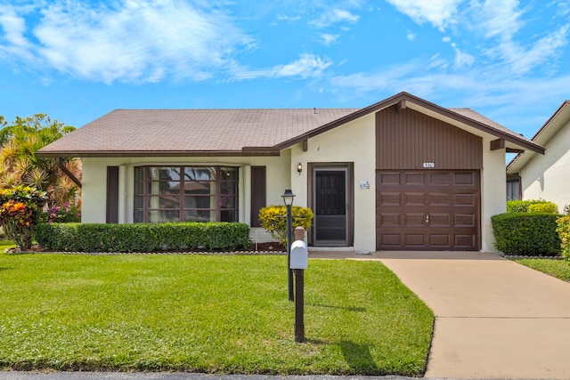 ranch-style house with a garage and a front yard