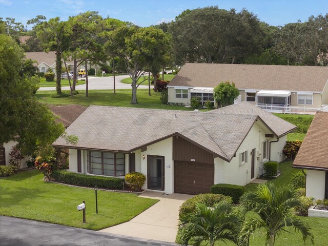 single story home featuring a front yard and a garage