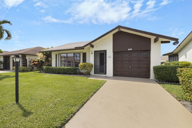 ranch-style house featuring a garage and a front yard