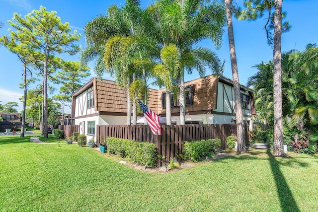 view of side of property with a lawn