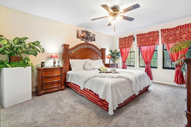 carpeted bedroom featuring a textured ceiling and ceiling fan