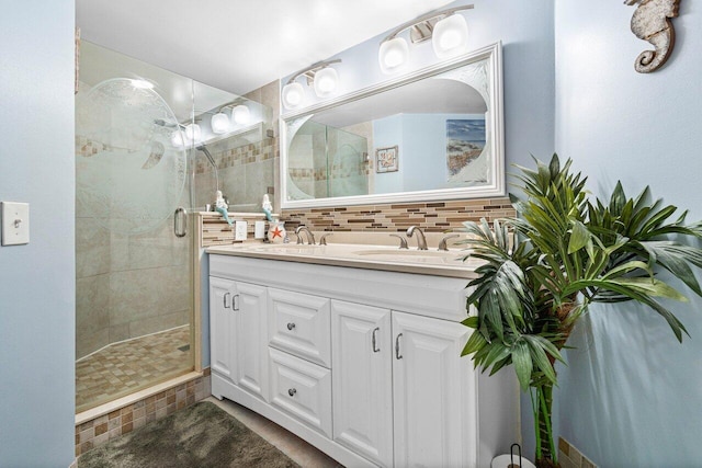 bathroom featuring walk in shower, tasteful backsplash, and dual bowl vanity