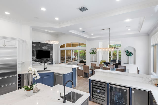 kitchen featuring light hardwood / wood-style flooring, sink, and beverage cooler