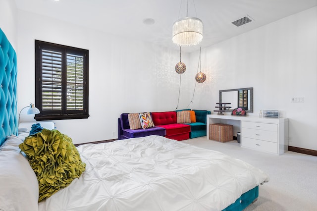 carpeted bedroom featuring a chandelier