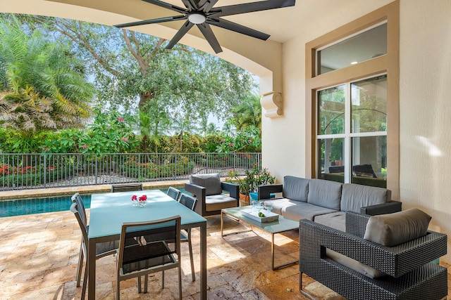 view of patio / terrace featuring ceiling fan, an outdoor hangout area, and a fenced in pool