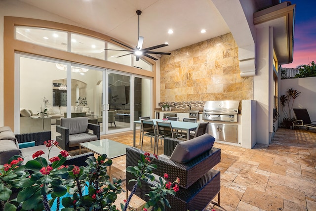 patio terrace at dusk featuring ceiling fan, an outdoor living space, and area for grilling